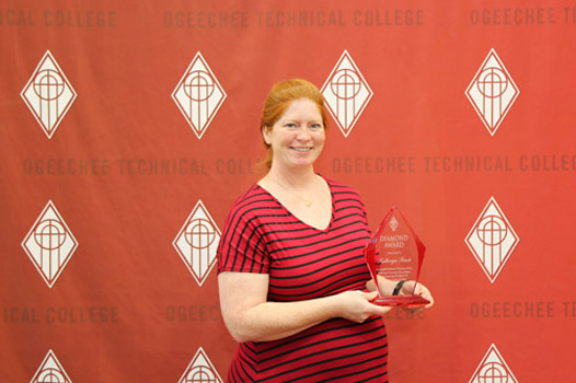 Kathryn Finch posing with Diamond Award